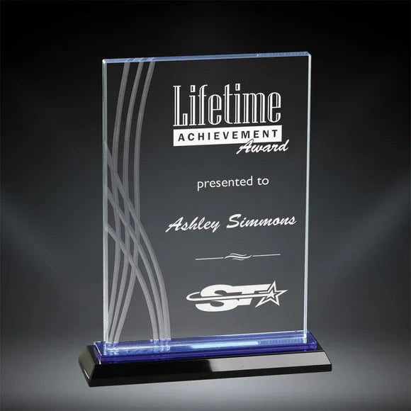 Boca Crystal Award for Lifetime Achievement, presented to Ashley Simmons, with etched wavy lines and blue light base.