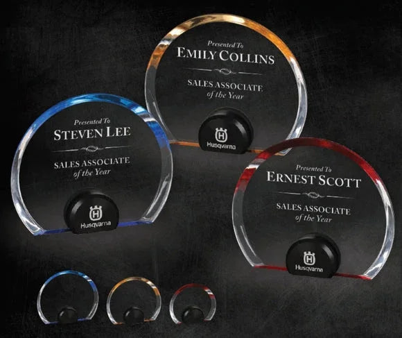 Three AwardsHere Halo Circle Acrylic Awards, clear with blue, gold, red accents, engraved as Sales Associate of the Year awards