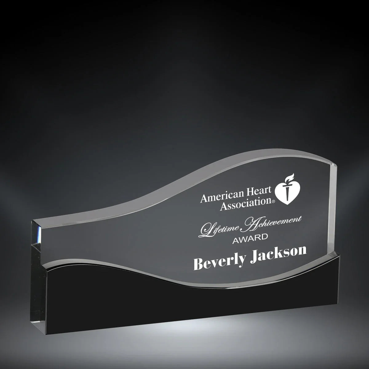 Vista Crystal Award from AwardsHere, clear wavy award with black base, engraved American Heart Association Lifetime Achievement.