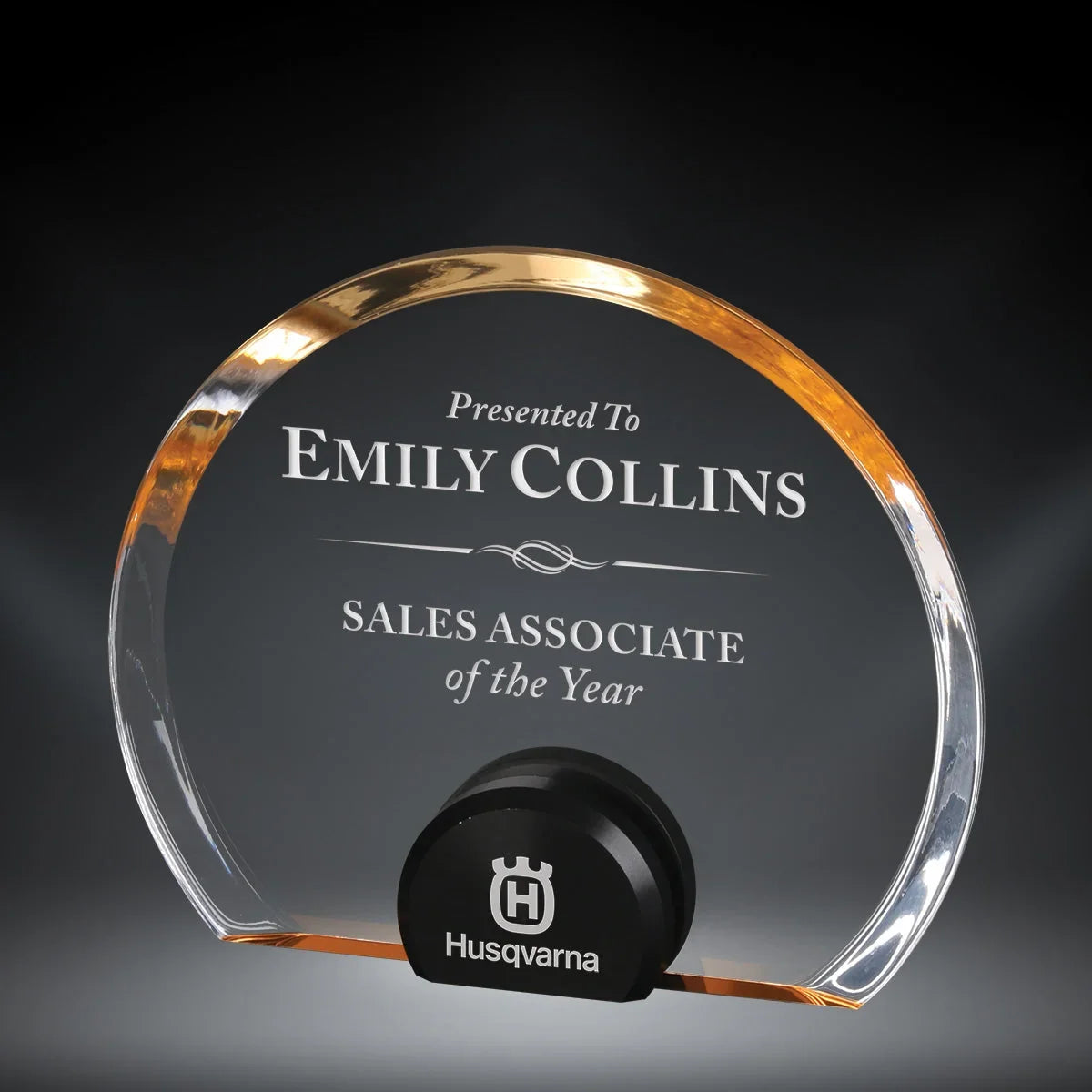 AwardsHere Halo Circle Acrylic Award, clear with gold trim, engraved for 'Emily Collins Sales Associate of the Year' with Husqvarna logo.
